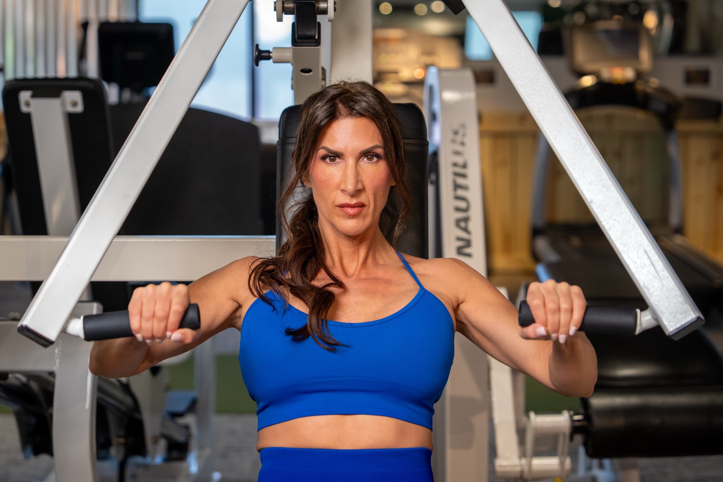 Stephanie mid-set on a chest press machine